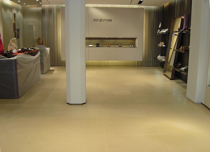 Finishing, protective, and stain-resistant treatment on limestone flooring in a public setting Treatment with stain-resistant protection on high-end limestone flooring in a shoe store
