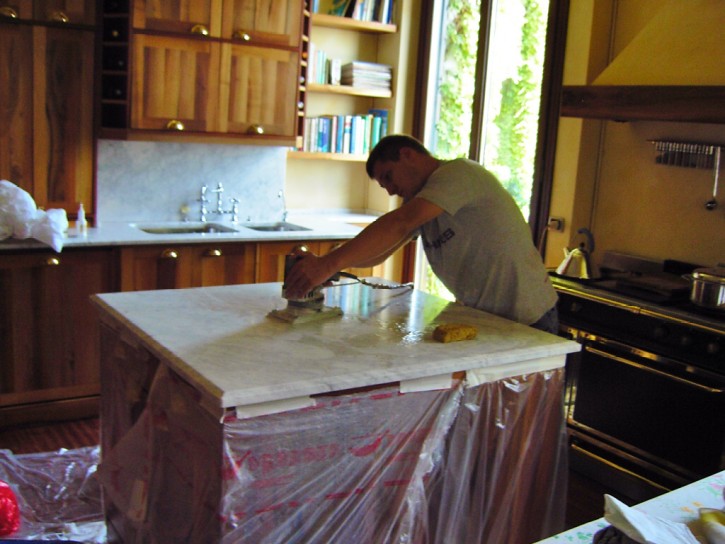 Re-polishing of the marble kitchen countertop Re-polishing of the marble kitchen countertop in a finished and furnished environment